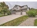 Well-maintained two-story home with a three-car garage, landscaping, and a welcoming front porch at 8317 Liverpool Cir, Littleton, CO 80125