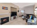 Inviting living room with a cozy fireplace, comfortable seating, and plenty of natural light at 5800 Tower Rd # 610, Denver, CO 80249