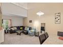Inviting living room with high ceilings, ample natural light, and comfortable seating area at 5800 Tower Rd # 610, Denver, CO 80249