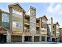 Exterior of condos showing stone accents, wood siding, and multiple balconies at 8489 Canyon Rim Cir # 302, Englewood, CO 80112