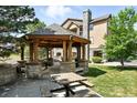 Community gazebo featuring seating and stone supports at 8489 Canyon Rim Cir # 302, Englewood, CO 80112