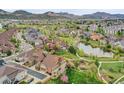 Scenic aerial view of neighborhood featuring tree-lined streets, a pond, and lush green spaces at 5781 S Union Ter, Littleton, CO 80127