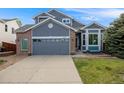 Charming two-story home featuring a two-car garage, manicured lawn and welcoming entryway at 16839 Trail View Cir, Parker, CO 80134