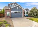 Charming two-story home featuring a two-car garage, manicured lawn and welcoming entryway at 16839 Trail View Cir, Parker, CO 80134