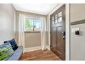 Welcoming entryway featuring a window with curtains and a cozy bench at 4720 W 39Th Ave, Denver, CO 80212