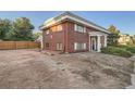 Side view of a brick building showcasing a landscaped yard and parking area at 450 W Jefferson Ave, Englewood, CO 80110