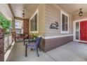 Cozy front porch with comfortable seating, decorative lighting, and stylish accents at 4385 Oakes Mill Ct, Castle Rock, CO 80109