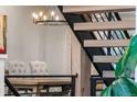 Modern staircase with wood steps, iron risers, and pendant lighting providing an architectural focal point at 24005 High Meadow Dr, Golden, CO 80401