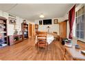 Cozy dining room with laminate flooring and abundant natural light at 12317 Fillmore Ct, Thornton, CO 80241