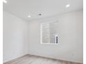 Bright bedroom featuring neutral walls, recessed lighting, and a large window for natural light at 24777 E 40Th Ave, Aurora, CO 80019
