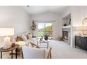 Cozy living room with a fireplace, balcony access, and ample natural light at 11364 Xavier Dr # 205, Westminster, CO 80031