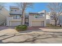 Modern home exterior with a two-car garage, balcony, and well-maintained landscaping at 9200 E Cherry Creek South Dr # 10, Denver, CO 80231