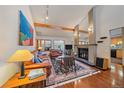 Cozy living room featuring hardwood floors, a fireplace, and comfortable leather furniture at 9200 E Cherry Creek South Dr # 10, Denver, CO 80231