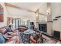 Spacious living room with a fireplace, leather furniture, and large windows at 9200 E Cherry Creek South Dr # 10, Denver, CO 80231