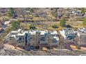 Aerial view of modern townhomes with neutral exteriors, landscaping, and nearby trees at 9200 E Cherry Creek South Dr # 10, Denver, CO 80231