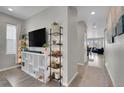 Bright entryway with built-in shelving, hardwood floors, and view into living room at 27891 E 7Th Ave, Aurora, CO 80018