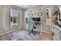 Home office with a modern desk, ergonomic chair, and ample natural light at 27891 E 7Th Ave, Aurora, CO 80018