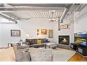 Comfortable living room showcases a fireplace, hardwood floors, and modern lighting for a welcoming atmosphere at 1435 Wazee St # 504, Denver, CO 80202