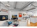 Bright and airy living area boasts a cozy fireplace, hardwood floors and a seamless flow to the kitchen at 1435 Wazee St # 504, Denver, CO 80202