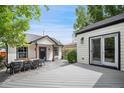 Inviting backyard with a dining area, patio, and well-maintained siding on a detached building at 1016 S Cook St, Denver, CO 80209