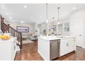 Open-concept kitchen with white cabinets, stainless steel appliances, and a center island at 8768 E 54Th Pl, Denver, CO 80238