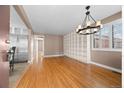 Spacious living room with hardwood floors, built-in shelving, and a chandelier for a modern touch at 536 Detroit St, Denver, CO 80206