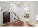 Bright foyer with hardwood floors, an elegant staircase, and access to a cozy living space at 165 N High St, Denver, CO 80218