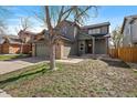 Charming two-story home with an attached two-car garage and well-maintained lawn at 5586 S Harlan St, Littleton, CO 80123