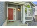 Inviting entryway featuring a red front door, white columns, and tasteful outdoor decor at 9008 W 101St Ave, Broomfield, CO 80021