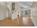 Open-concept living space with hardwood floors, staircase, and abundant natural light at 9008 W 101St Ave, Broomfield, CO 80021
