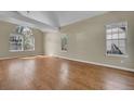 Bright living room with hardwood floors, large windows, and vaulted ceilings at 9008 W 101St Ave, Broomfield, CO 80021