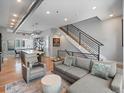 Spacious living room with hardwood floors, open layout, modern staircase, and comfortable seating area at 2833 W 25Th Ave # 5, Denver, CO 80211