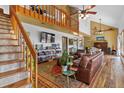 Spacious living room featuring high ceilings, a loft, and hardwood floors with rustic furnishings at 4664 S Union St, Morrison, CO 80465