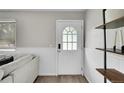 Bright entryway featuring a stylish door, wood floors, and sleek shelving at 4259 S Richfield St, Aurora, CO 80013