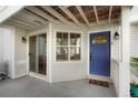 Welcoming entrance with a blue front door, covered porch, and adjacent sliding glass door access at 12593 E Pacific Cir # E, Aurora, CO 80014