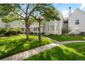 Beautifully landscaped townhome community with lush green lawns, mature trees, and well-maintained exteriors at 12593 E Pacific Cir # E, Aurora, CO 80014