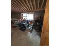 Spacious room with exposed ceiling beams, ample natural light, and some storage items at 325 Aspen Rd, Idaho Springs, CO 80452