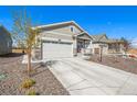 Charming one-story home featuring neutral siding, a front porch, a well-maintained lawn, and an attached garage at 15979 Xanthia Way, Thornton, CO 80602