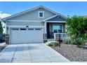 Charming single-Gathering home featuring a well-manicured front yard, covered porch, and a two-car garage at 15979 Xanthia Way, Thornton, CO 80602