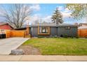 Charming single-story home with a well-maintained lawn and a modern gray brick exterior at 9380 W 51St Ave, Arvada, CO 80002