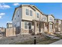 Townhouse exterior featuring neutral siding, stone accents, and a well-maintained landscape at 13734 Ash Cir, Brighton, CO 80602