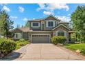 Charming two-story home with a well-maintained lawn and a spacious driveway at 15904 W 58Th Ave, Golden, CO 80403