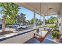 Relaxing front porch with a hanging swing, offering a serene outdoor living space at 2426 S Acoma St, Denver, CO 80223