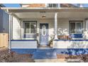 Inviting front porch featuring classic columns, a wooden bench, and stylish details at 2426 S Acoma St, Denver, CO 80223