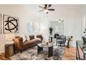 Bright living room featuring modern furnishings, a ceiling fan, and neutral paint at 2426 S Acoma St, Denver, CO 80223