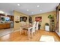 Bright dining room features hardwood floors and a view into the kitchen at 10972 Fairfax Ct, Thornton, CO 80233