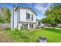 Well-maintained lawn and flower beds enhance the charm of this two-story home at 10972 Fairfax Ct, Thornton, CO 80233