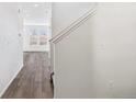 Bright hallway with hardwood floors leading to the living room at 13372 E 110Th Way, Commerce City, CO 80022