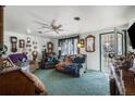 View of a living room with a ceiling fan and an exterior door at 3778 S Hooker St, Englewood, CO 80110