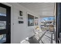 Charming front porch with seating, stylish black door, and ample natural light at 3285 S Emerson St, Englewood, CO 80113